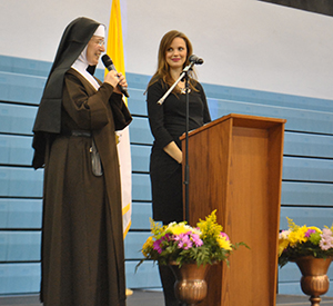 Sister Grace Helena, a Carmelite of the Most Sacred Heart and campus minister at Archbishop Coleman Carroll High School in Miami, introduces Leah Darrow, former America's Top Model contestant and now a speaker on modesty, chastity and relationships, to women participating in a Sunday tea at the school's gym.