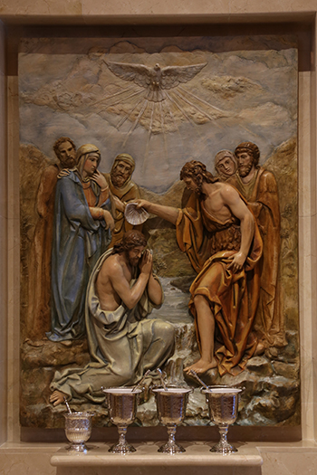 The new baptistery at Our Lady of Lourdes Church features a beautiful relief depicting the baptism of Jesus.