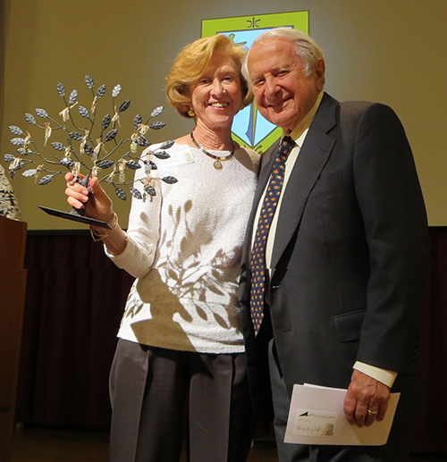 Wini and Joe Amaturo pose with the specially crafted "tree of thanks" they received in appreciation of their 10 years of financial support to Catholic school children via the implementation of Accelerated Reader and Math programs.