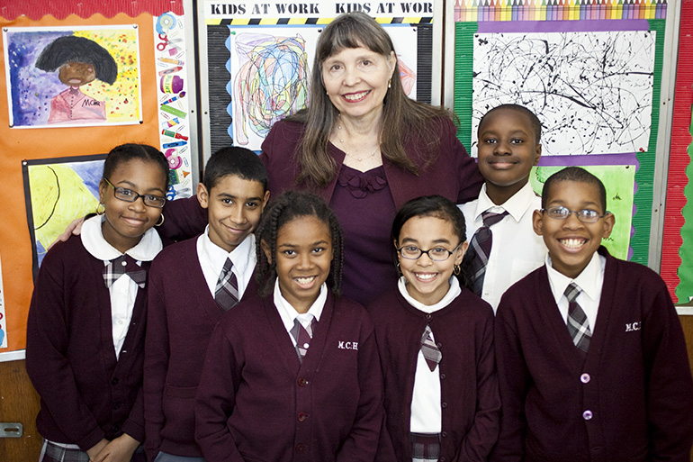 Suzanne Kaszynski, principal of Mt. Carmel-Holy Rosary School in New York City, is pictured here with some of the students of the Harlem school.