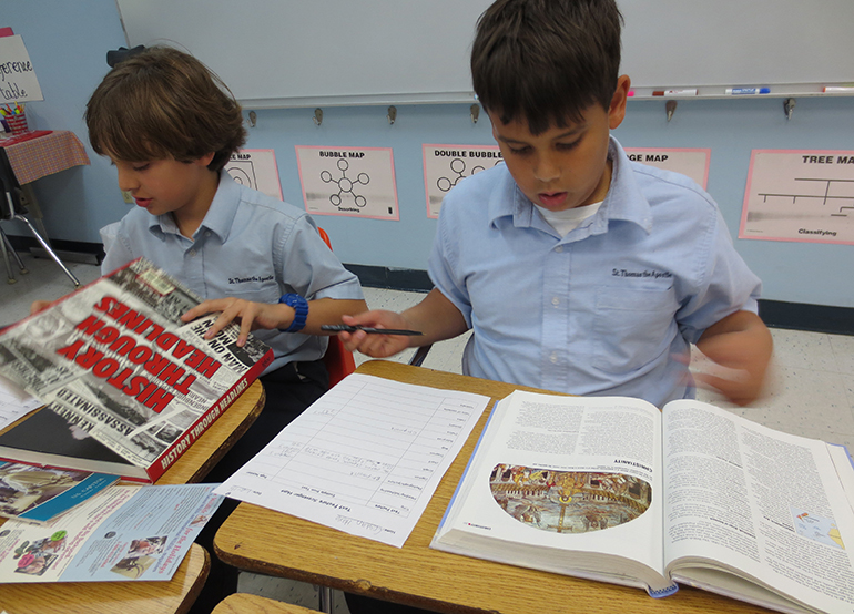 With a sense of a rush, fifth graders Cristian Hoya and Michael Merin flip through pages of various books during a research scavenger hunt. While the students have access to tablets, laptops and desktops, gifted Language Arts fifth grade teacher Lissett Navarro-Ruiz reminds them that books are still an essential part of research.