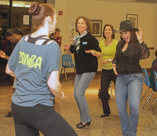 Zumba teacher Courtney Stewart leads St. Gregory Women's Guild members Cynthia Januszka, Theresa Chen and line dancing teacher Lisa Spangler in the fitness dance, which was part of the group's activities at their January meeting.