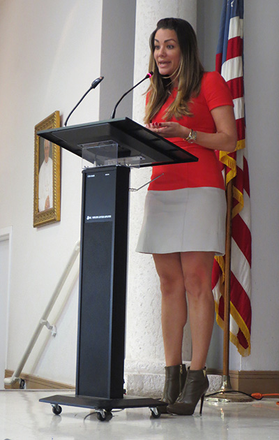 Univision 23 weekend anchor Gloria Ordaz provides opening remarks before the start of the second annual Archdiocese of Miami Spanish Spelling Bee hosted by Blessed Trinity School. Ordaz encouraged students to embrace the Spanish language.