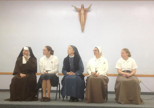 Sisters from various communities (Carmelites, Servants of the Pierced Hearts, and Daughters of St. Paul) participate in a panel to answer questions from sixth grade girls at the Focus 11 Vocation Rally at St. Agatha.