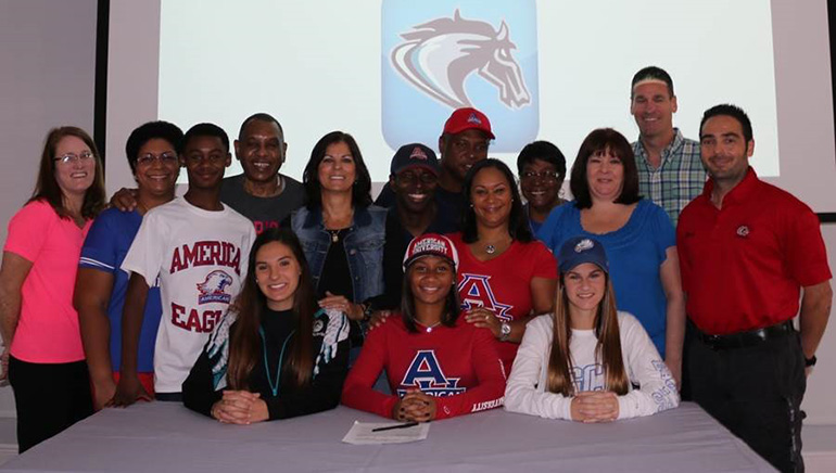 Archbishop Edward A. McCarthy High School student athletes (seated) pose following the signing of their National Letters of Intent and the luncheon that followed with their families, friends and coaches. Seated from left to right: Yarisbeth Bradfield, Taylor Shore and Katie McInnis. Not pictured: Brian Van Belle of Pembroke Pines.