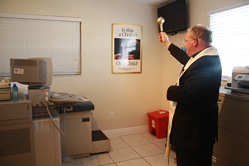 Bishop Peter Balducchino blesses the ultrasound room at the new office of the South Dade Pregnancy Help Center.