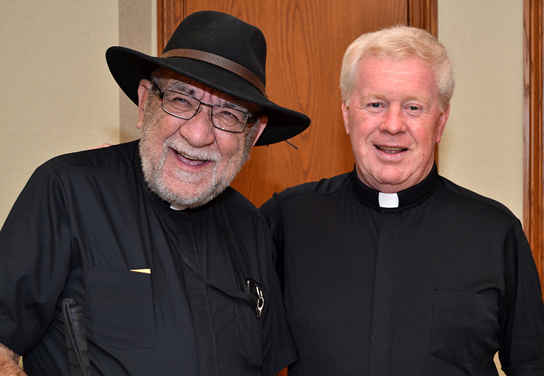 Father Pat Martin, left, chums around with Father Edmond Prendergast after celebrating a Vigil Mass at St. Bonaventure Church, Davie, where Father Prendergast is pastor.