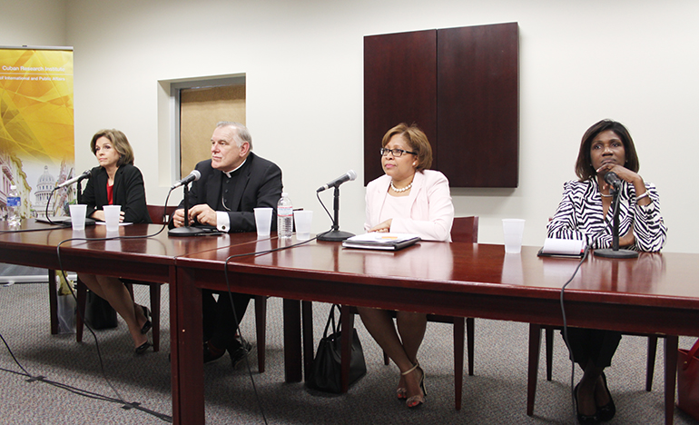 Panelists at the FIU discussion on immigration reform were, from left: Helen Aguirre Ferre, journalist and political anylist; Archbishop Thomas Wenski, a member of the U.S. bishops' Committee on Immigration; Dahlia Walker-Huntington, immigration attorney; and Gepsie Metellus, executive director of the Sant La Haitian Neighborhood Center.