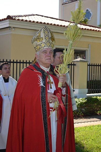 Archbishop Thomas Wenski begins to process into St. Mary Cathedral on Palm Sunday.