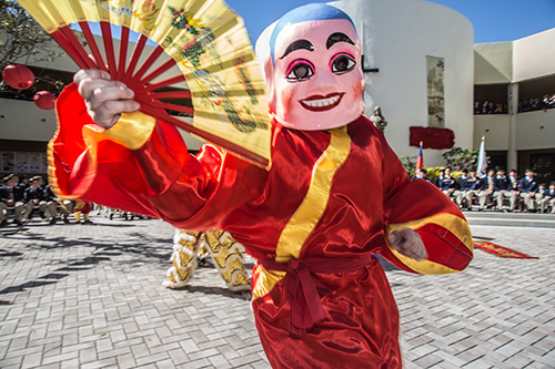 Roman Newman wears a Buddha face while performing a Lion Dance at Belen Jesuit Prep. He is a member of Lee Koon Hung Kung Fu Association and Lion Dance team.