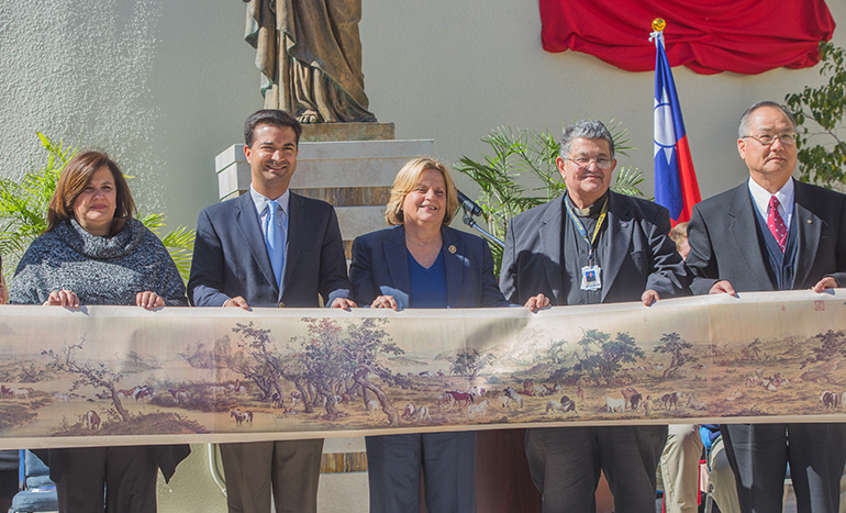 Holding a silk replica of the masterpiece "One hundred horses," painted in 1728 by the Jesuit painter and Brother Giuseppe Castiglione, from left: Maria Cristina Reyes-Garcia, Belen Jesuit Prep principal; U.S. Rep. Carlos Curbelo, Belen class of 1998; U.S. Rep. Ileana Ros-Lehtinen; Jesuit Father Pedro Suarez, Belen president; and Philip Wang, director general of the Taipei Economic and Cultural Office in Miami, who presented the school with the replica.