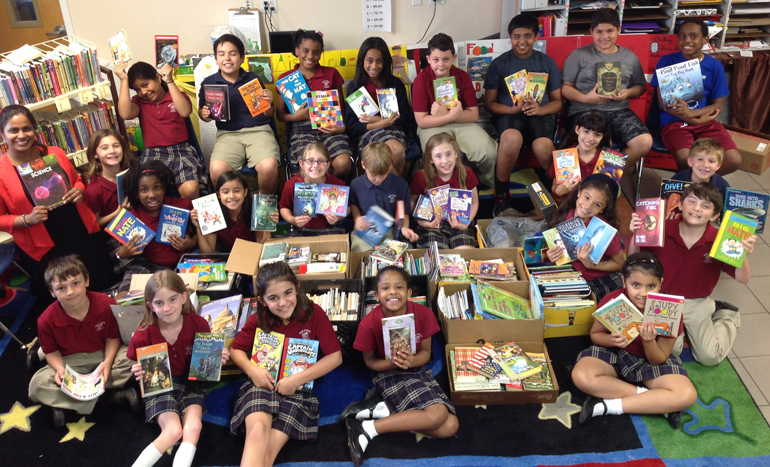 Julia Matchanickal and her fourth grade class show the books collected as gifts for children suffering from temporary or terminal illnesses at Chris Evert Hospital.