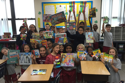 A third grade class from St. Andrew School displays some of the toys and books they collected for Chris Evert Children's Hospital in Fort Lauderdale. Not pictured is teacher Gina Provost.