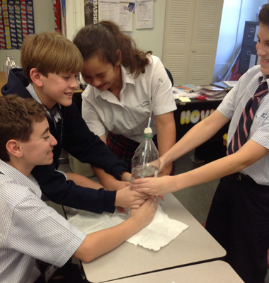 Run for cover! Students at St. Brendan Elementary experiment with air pressure using a custom-made barometer.