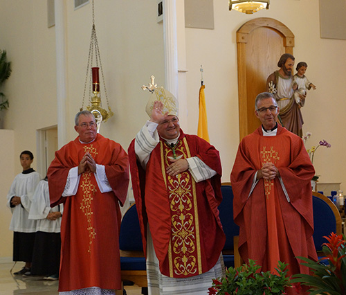 Auxiliary Bishop Peter Baldacchino thanks the singers in the choir loft at the end of the Red Mass.