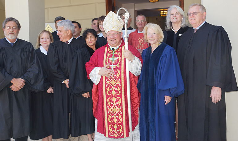 Auxiliary Bishop Peter Baldacchino poses with Monroe County judges at the conclusion of the annual Red Mass.