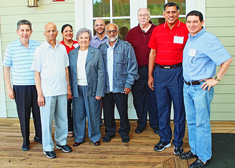 Father Augustine Mendonca, second from left, poses with the judges and staff of the Metropolitan Tribunal of the Archdiocese of Miami. From left: Father Luis Garcia, Goretti Anthony, Sister Jeanne-Margaret McNally, Father Luis Rivero, Father Mathew Thundathil, Father Father Francis Cancro, Msgr. George Puthusseril and Roberto Aguirre.