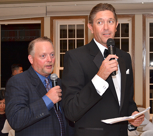 Brad Goodchild, left, and Graham Lord share auctioneer duties at a recent St. Jerome fundraiser.