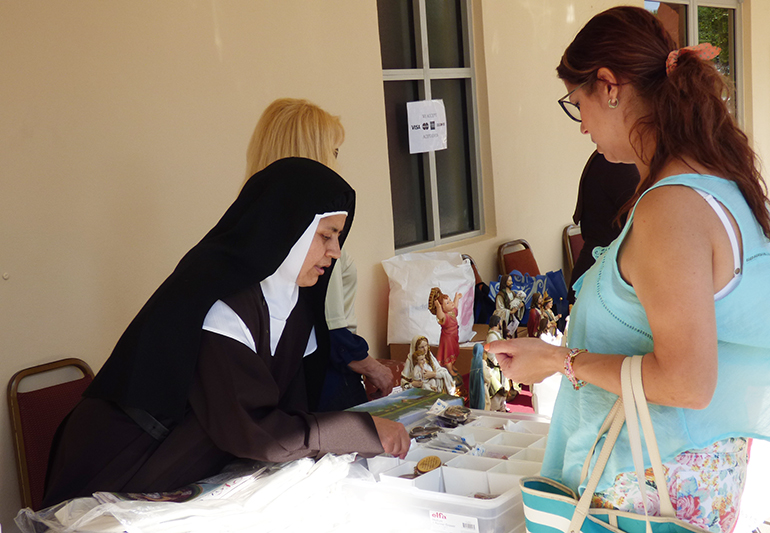 Mother Blanca Flor sells religious articles after Mass at a local parish.