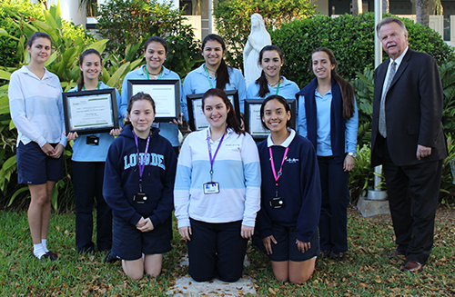 Toshiba Representative Gary Miller poses with Lourdes Academy's 2013, 2014 and 2015 ExploraVision regional winners. The 2013 team went on to win second place in the national competition that year. Lourdes Academy also is the only school in the nation to have three consecutive regional wins.