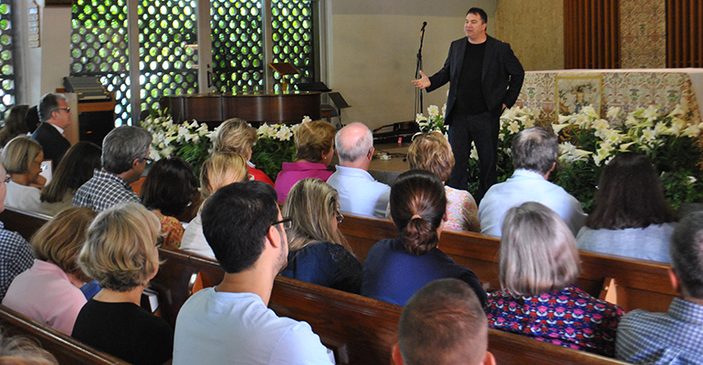 The crowd listens as Matthew Kelly talks on how to become the "best version of yourself" at St. Augustine Church and Catholic Student Center April 11. Kelly's mission is to motivate Catholics to embrace their faith and live it in a dynamic way.