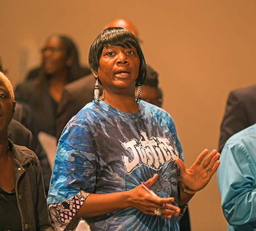 Deborah Pride sings during the opening of PACT's Nehemiah Action Assembly. She spoke to the assembly about her homelessness.