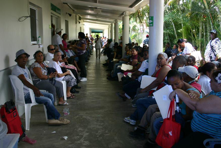 Patients line a walkway outside the Hospital Manuel J. Centurion at ILAC Center in Santiago, Dominican Republic, while waiting to be examined by volunteer medical personnel from South Florida. The medical mission is one of two undertaken each year by members of the South Florida-based Cuban Association of the Order of Malta.