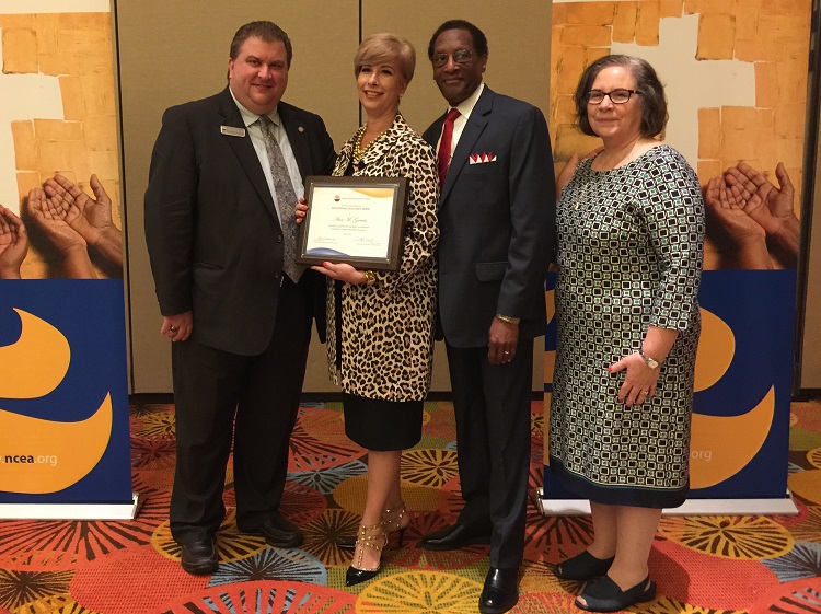 Ana Garcia, principal of Msgr. Edward Pace High School, second from left, poses for a photo after receiving her NCEA Secondary Schools Department Educational Excellence Award. From left: Christopher Cosentino, NCEA Interim Director for Secondary Schools, Donald Edwards, associate superintendent of schools for the Archdiocese of Miami, and Mary Anne Beiting, president of the NCEA Secondary Schools Department Executive Committee.