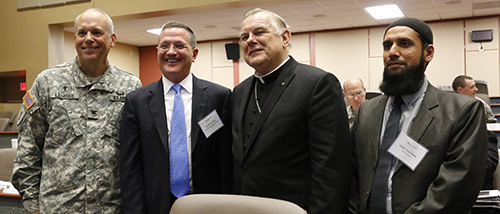 Command Chaplain Col. Michael Lembke poses with most of the keynote speakers at the Religion Matters II conference, from left: Brian Grim, president of the Religious Freedom and Business Foundation; Archbishop Thomas Wenski; and Imam Asim Hafiz, Islamic religious advisor to the Ministry of Defence of the United Kingdom.