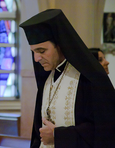 Msgr. Michael Souckar, pastor of St. Andrew Church in Coral Springs and an archimandrite in the Melkite Eparchy of Newton, processes into the Cathedral of St. Mary at the start of the Prayer Vigil for peace in the Middle East.