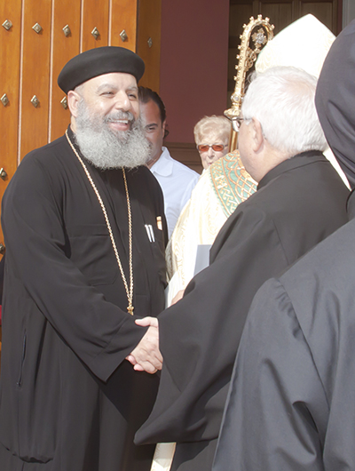 Father Timothy Soliman of St. John the Baptist Coptic Orthodox Church in Miramar, greets fellow clergy and parishioners at the end of the prayer vigil for peace in the Middle East.