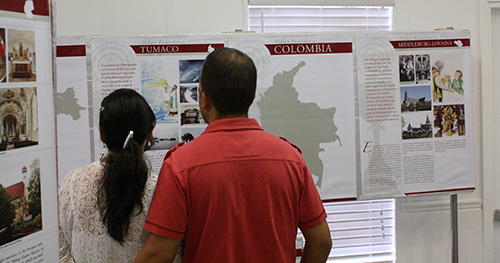 Parishioners and visitors to St. Boniface look over the "Miracles of the Eucharist" exhibit.