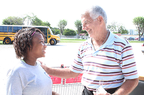 Our Lady Queen of Martyrs School seventh grader Alexus Metayer is greeted by San Jose Obrero Foundation volunteer Jorge Luis Delgado at San Lazaro Church. Alexus and her class came to personally deliver their clothing donation of 300 bags to Father Alejandro Lopez's foundation, which benefits the Choluteca community of Honduras.