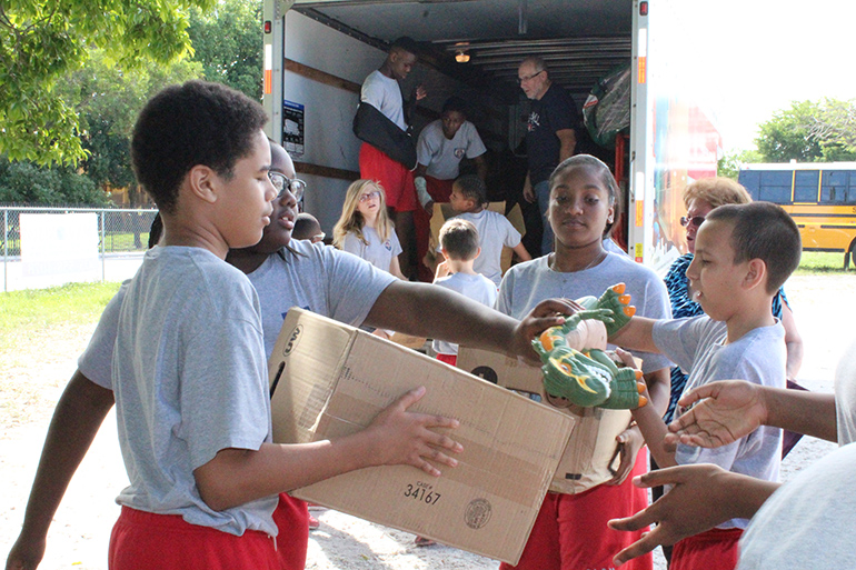 Pass the dinosaur, please. Toys, clothes, shoes, hats, and other items were among the donations collected by Our Lady Queen of Martyrs' seventh grade religion class.