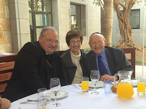 Miami Auxiliary Bishop Peter Baldacchino poses with Rabbi Solomon Schiff and his wife, Shirley, during one of their meals at the Domus Galilaeae during the meeting of Jewish and Catholic leaders, May 4-7 in Israel.