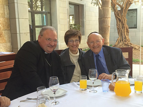Miami Auxiliary Bishop Peter Baldacchino poses with Rabbi Solomon Schiff and his wife, Shirley, during one of their meals at the Domus Galilaeae during the meeting of Jewish and Catholic leaders, May 4-7 in Israel.