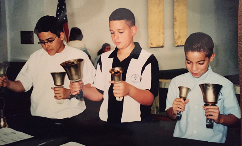 This photo shows Bryan Garcia, center, playing in the hand bell choir as a seventh grade student at Immaculate Conception School in Hialeah.