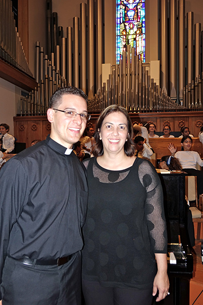 Soon-to-be Father Bryan Garcia poses with his elementary school choir director, Ysomar Granandos, who now directs the St. Bonaventure School Chorale.