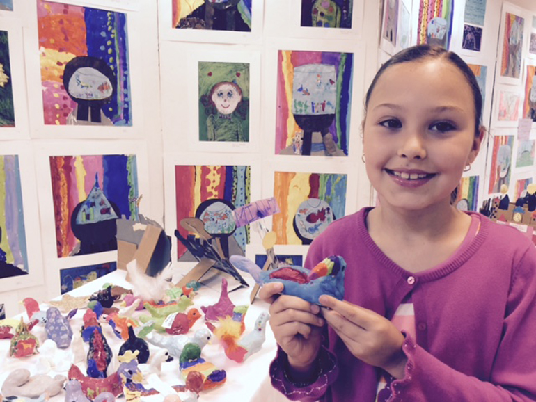 Birds of a feather flock together: Third grader Juliana Echeverri poses with a bird sculpture she made for the St. Agnes Academy Student Art Show.
