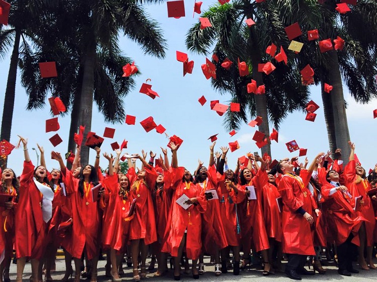Msgr. Edward Pace High School's class of 2015 throw their caps into the air after their graduation May 22.