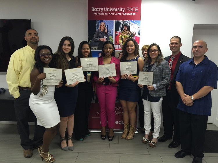 Posing with their graduation certifices, from left: Msgr. Pace Academy of Health Sciences Lead Teacher Kevin LaGrange, Pace EMT Academy graduates Mitchy Leandre, Carina Jatib, Juanesha Serra, Danielle Dalge, Michelle Montoya, Barry University's Terri Hernandez, EMT Academy graduate Sabrina Cabrera, EMT Program Director Jason Smith, and EMT Academy teacher Jorge Nunez.