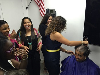 Msgr. Pace High EMT Academy graduate Michelle Montoya shaves Kevin LaGrange's head in front of her fellow graduates (from left) Mitchy Leandre, Danielle Dalge, Juanesha Serra, and Carina Jatib, as part of a new tradition for seniors graduating from Pace's Academy of Health Sciences.