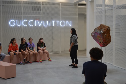 Crystal Molinary, Outreach Programs manager, introduces the students to the museum and GucciVuitton exhibit on view at the Institute of Contemporary Art in the Design District.