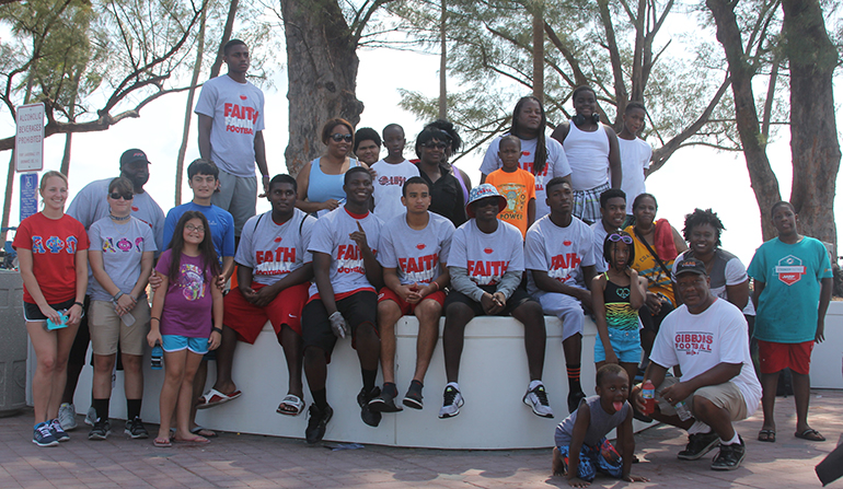 The second beach clean-up group, led by Cardinal Gibbons students Shawn Walker and Francesco Rizzo pose for a photo at their "work place."