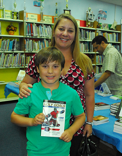 Ryan Alvarez, a St. Jerome fourth grader, shown here with his mother, Carolyn Alvarez, said they were delighted to find a Catholic-centric book about a hockey player at the first ever “Good News! Book Fair.”