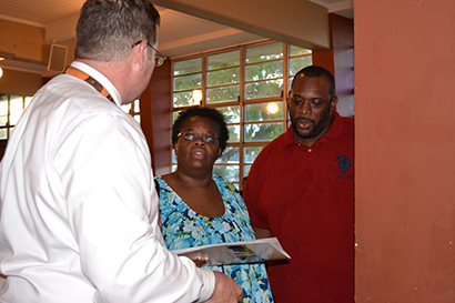 Principal Douglas Romanik of Archbishop Curley Notre Dame speaks to the Cozart family speaking about their two middle school students.