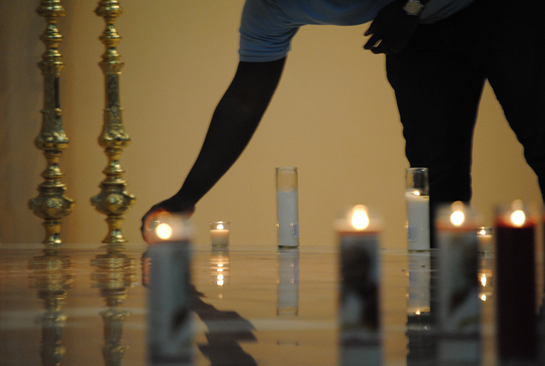 Candles are placed by the sanctuary to symbolize the call to be a light at the first archdiocesan Young Adult Ministry event.