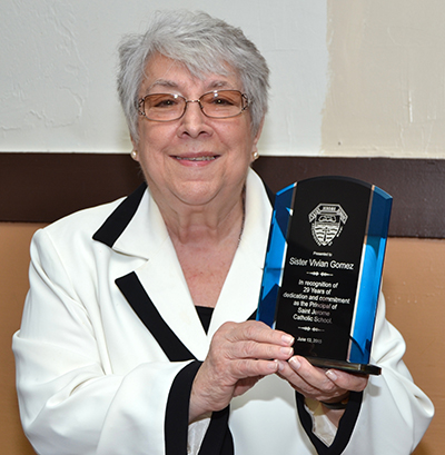 Sister Vivian shows a plaque in her honor for her 29 years as principal at St. Jerome School.