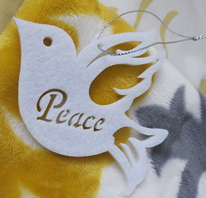 Dove ornaments like this one were given out to family members before the Mass, in hopes of sending a positive and lasting message of peace to those who have lost loved ones.