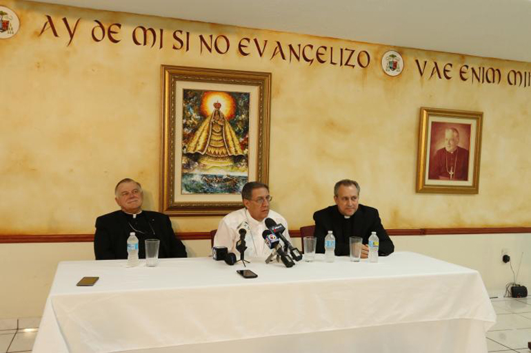 Bishop Arturo Gonzalez of Santa Clara, Cuba, answers reporters' questions at the press conference June 20. At left is Archbishop Thomas Wenski, and at right is Father Jose Alvarez, pastor of Our Lady of the Lakes in Miami Lakes, who organized this year's Cuba Diaspora Encuentro.